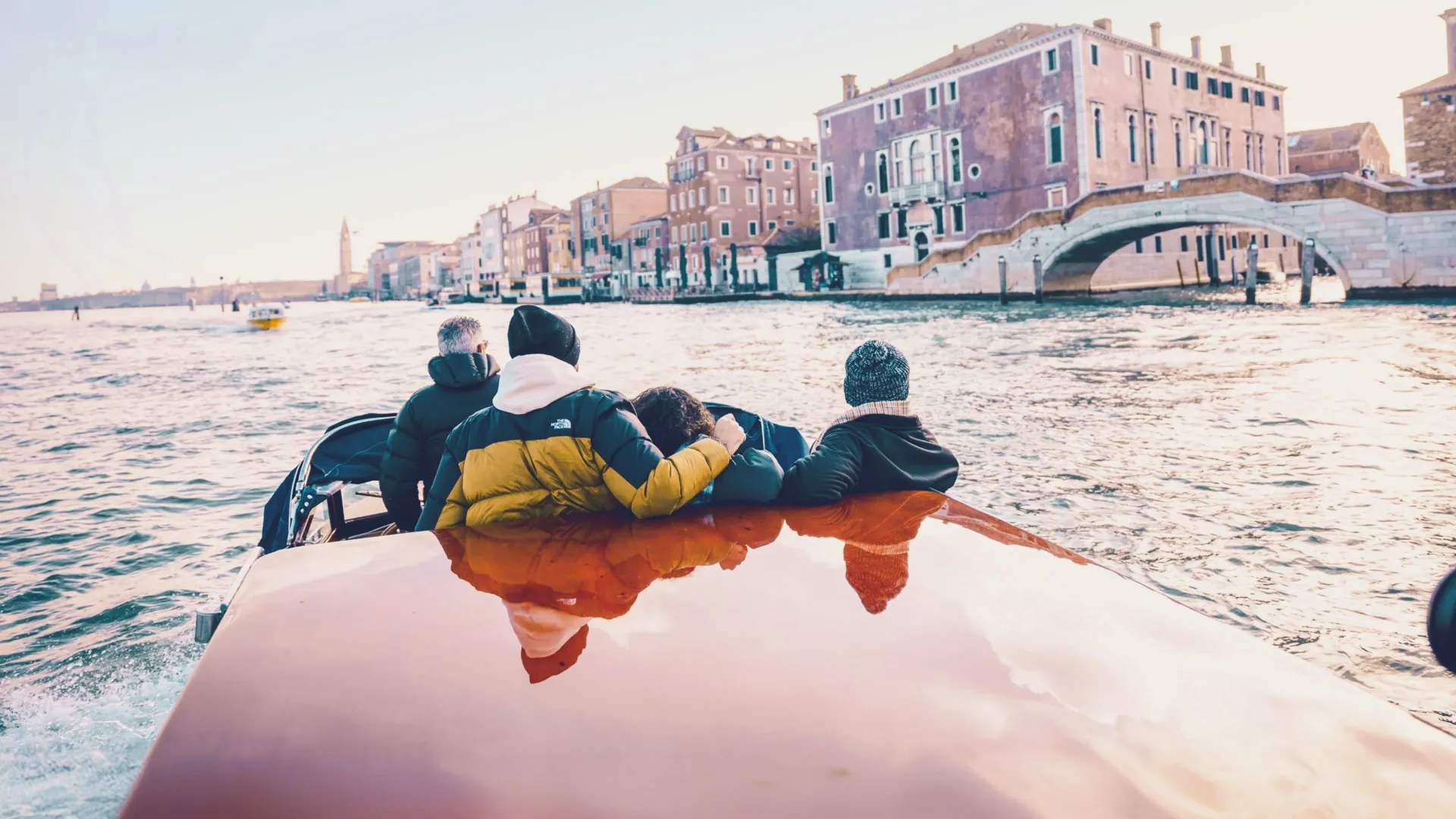 Travellers cruising through Venice by water taxi - Contiki Barcelona to London Quest Tour