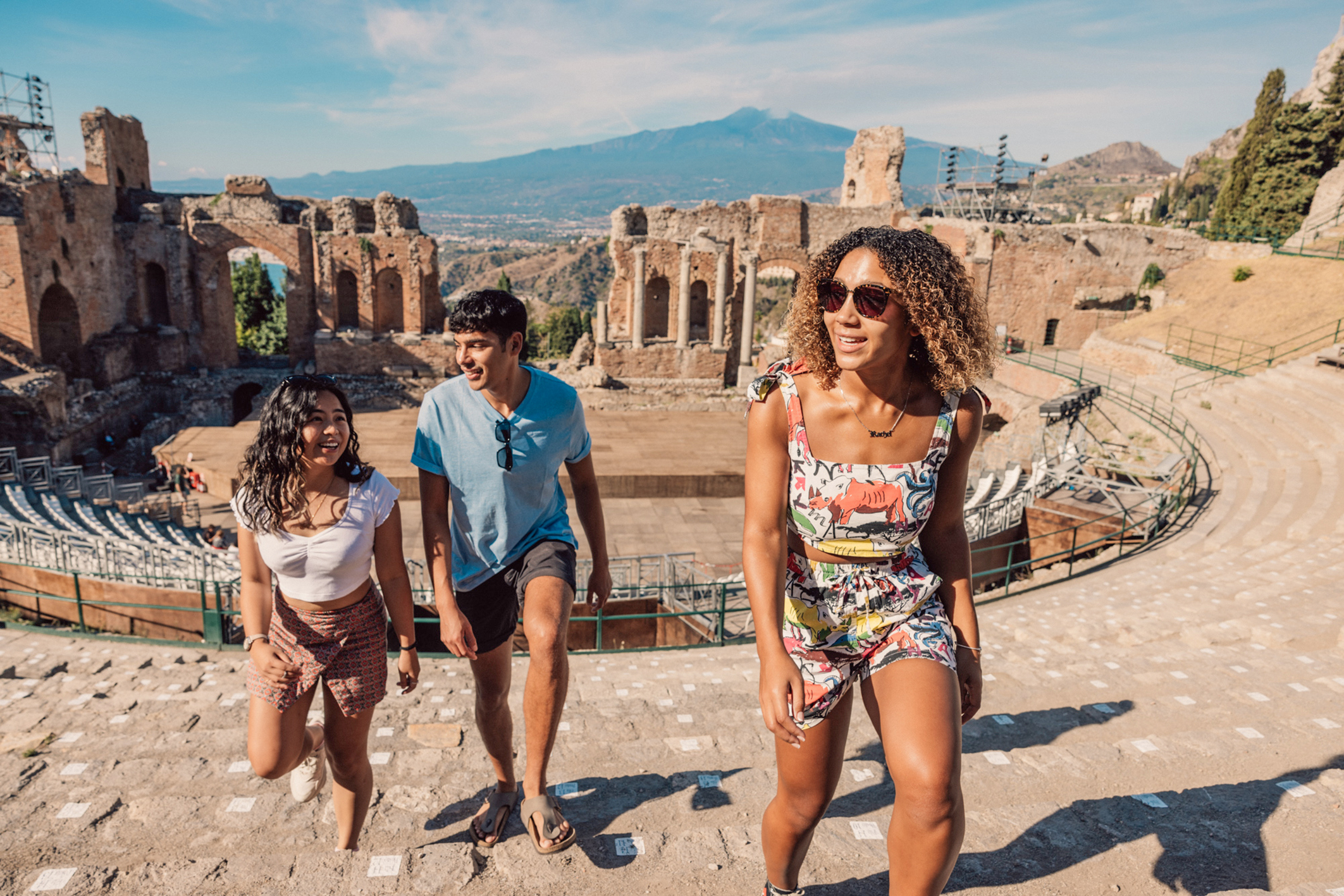 Travelers exploring the amphitheatre in Taormina, Sicily, Italy