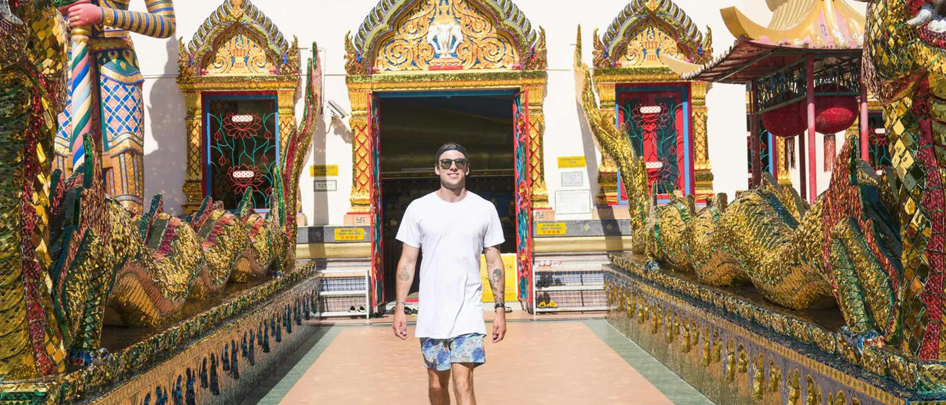 Traveller in front of Wat Chayamangkalaram shrine, Malaysia Traveller in front of Wat Chayamangkalaram shrine, Malaysia