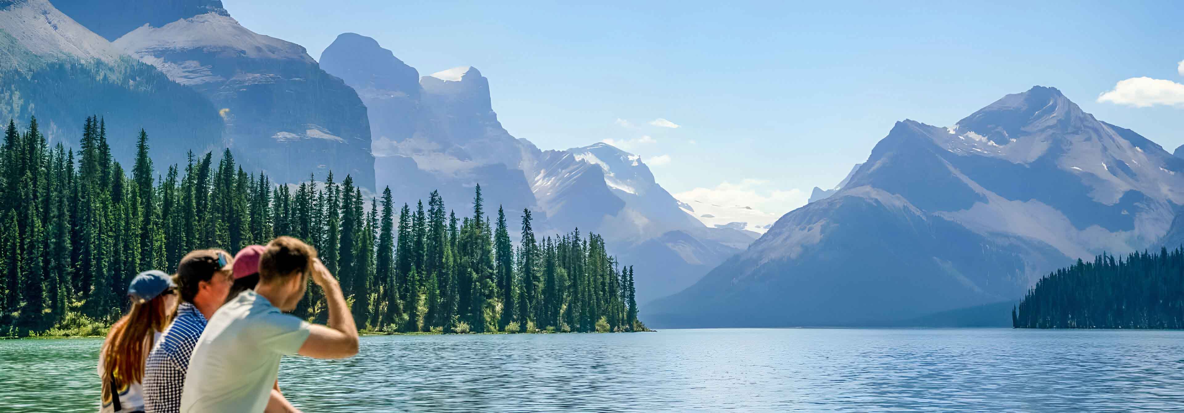 Group Of Young People Looking At A Lake And Mountain Landscape