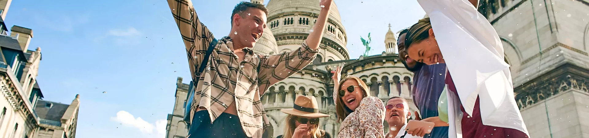People Happily Jumping Sunny Day Landmark As Background