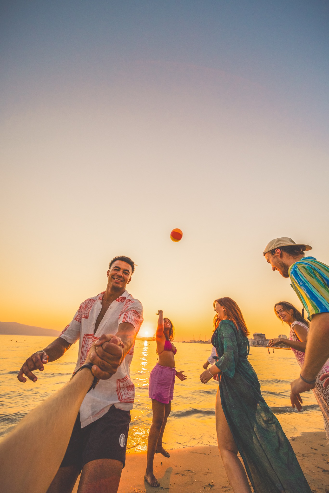 Group Of Young People Playing Vollyball On The Beach