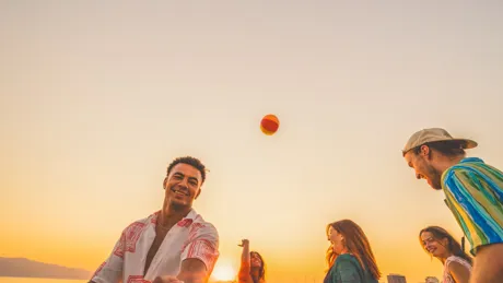 Group Of Young People Playing Vollyball On The Beach