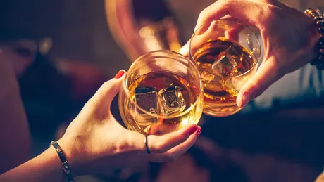 a-couple-makes-a-toast-with-two-glasses-of-whiskey.jpg