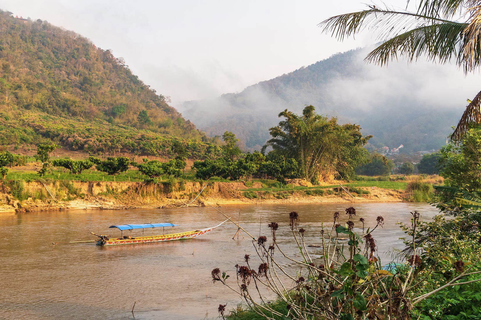 Longtail Boat on Kok River Surrounded by Tropical Mountains, Fang, Thailand