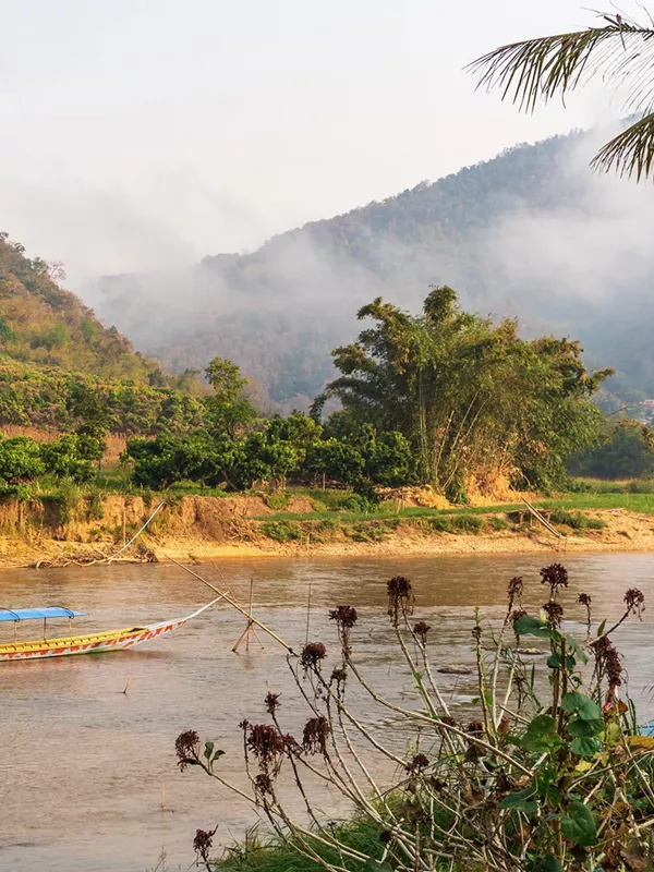 Longtail Boat on Kok River Surrounded by Tropical Mountains, Fang, Thailand