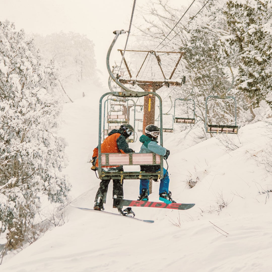 Snowboarders Ride Chairlift While Snowing Hakuba Japan