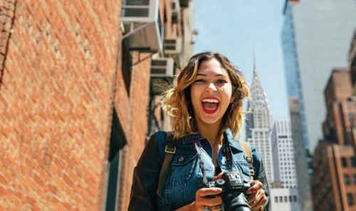 Young Woman Smiling While Holding Camera