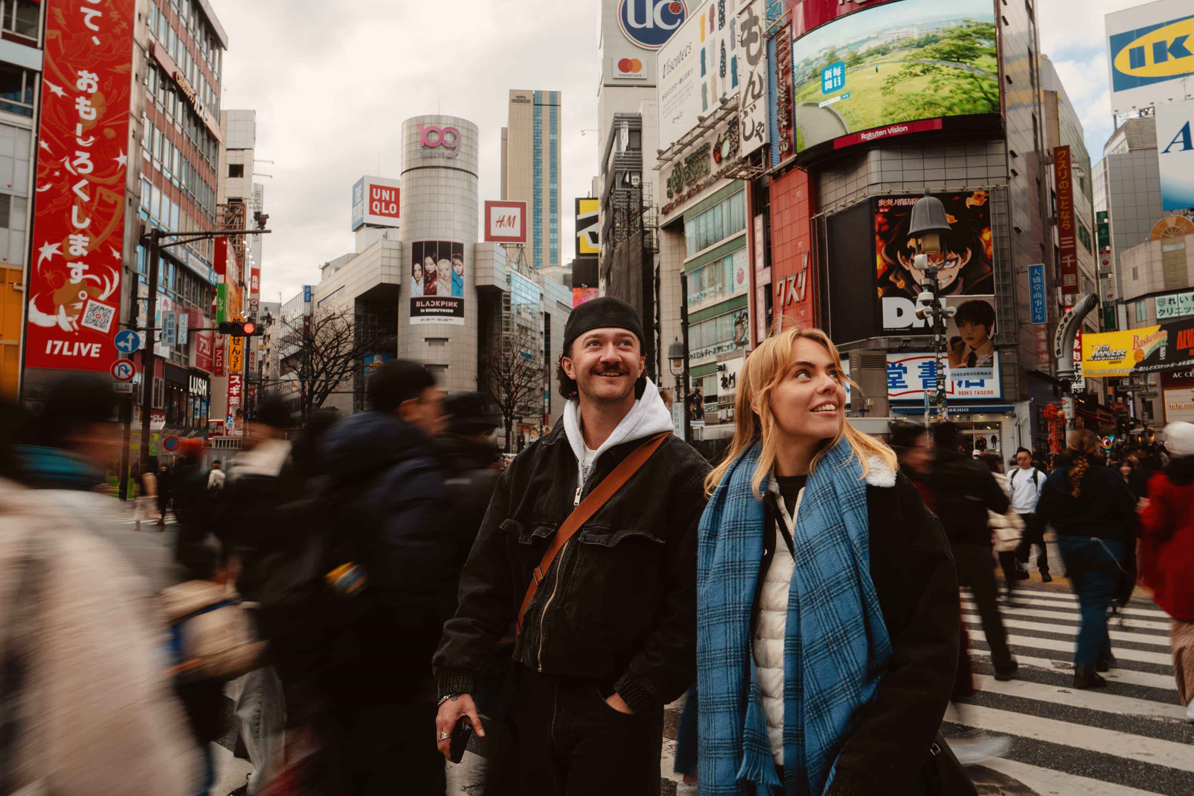 travellers-taking-in-the-neon-signs-and-crowds-crossing-shibuya-tokyo-japan.jpg