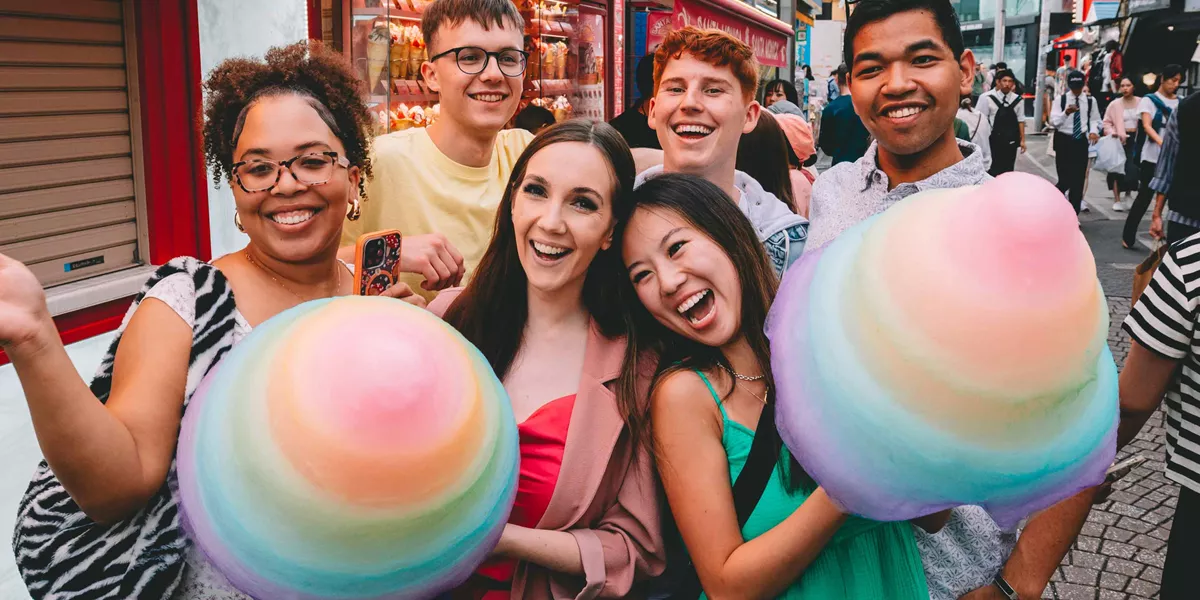 Group Of Young Travellers Having Fun On Harajuku Street Tokyo Japan