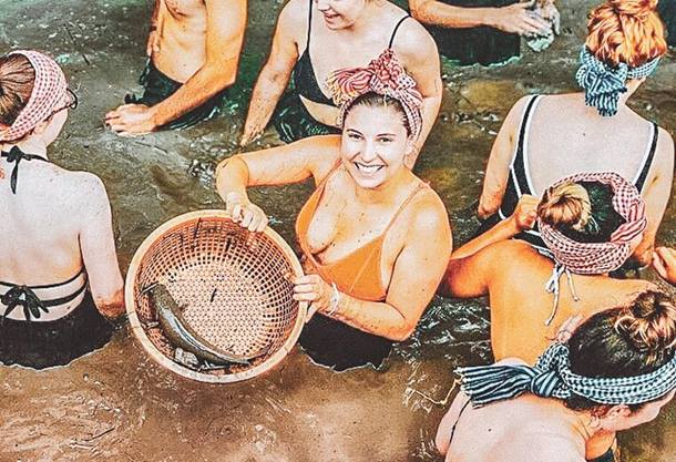 A group of women standing in the Mekong river