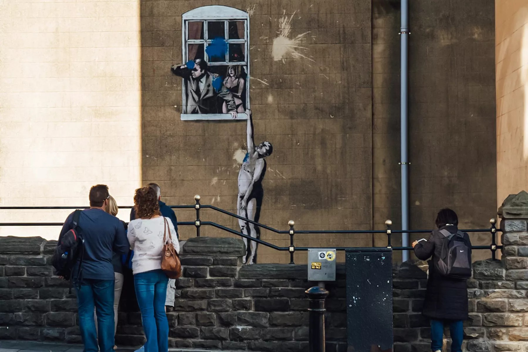 Travellers enjoying Banksy Street Art tour in Bristol UK