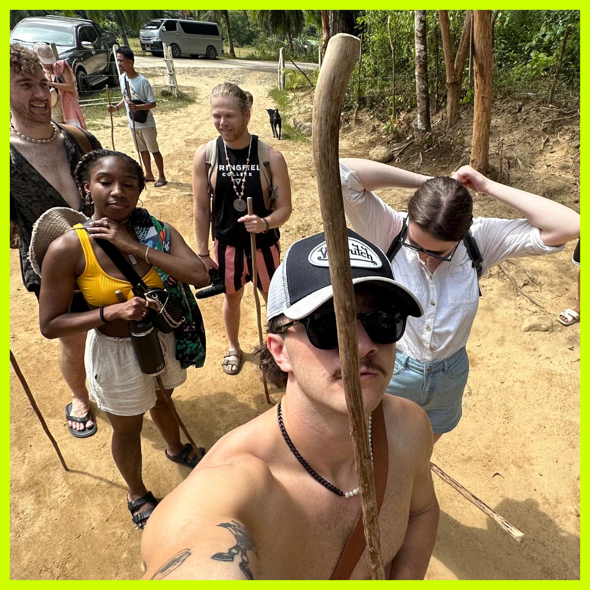 Influencer Nathan with a group of people holding wooden sticks