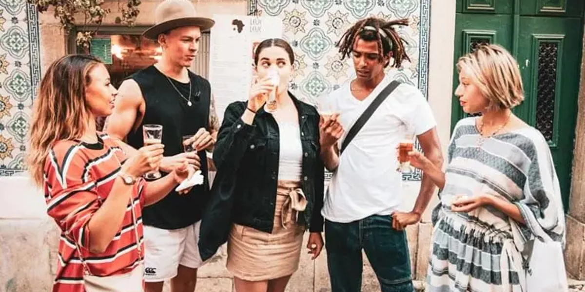 A Group of Pople Standing and Drinking Alcohol Together