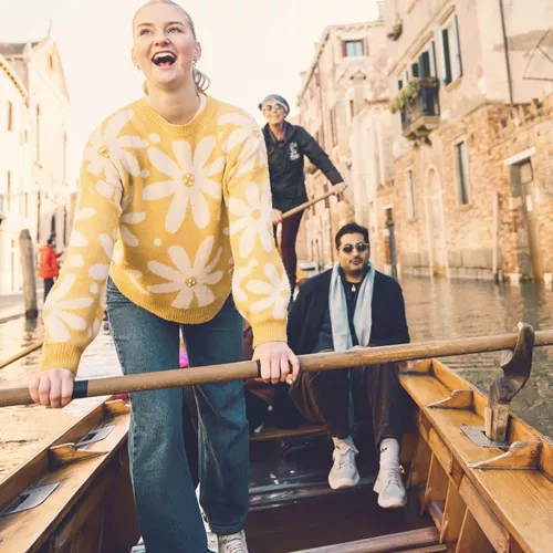 Contiki travellers glide through Venice's canals on a traditional gondola during the London to Rome Quest
