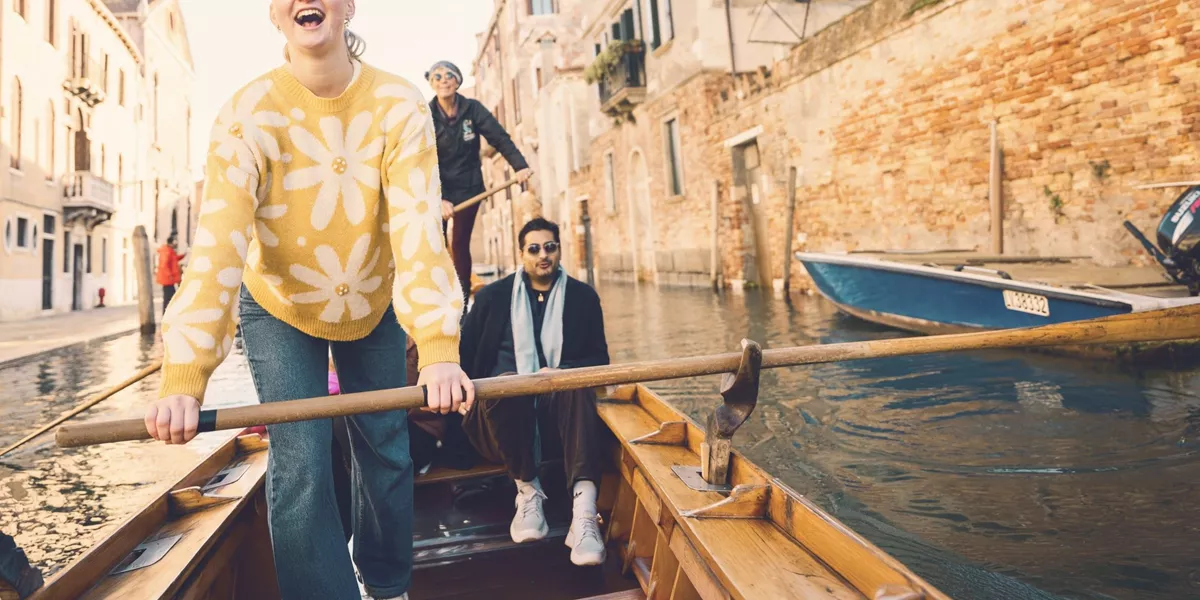 Contiki travellers glide through Venice's canals on a traditional gondola during the London to Rome Quest