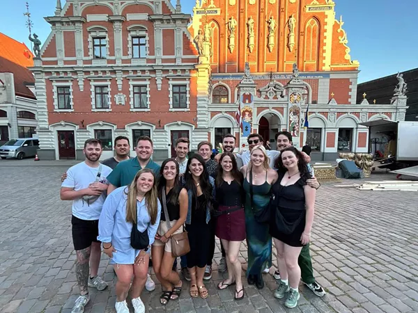 Large Group Of Friends Traditional Building At The Background