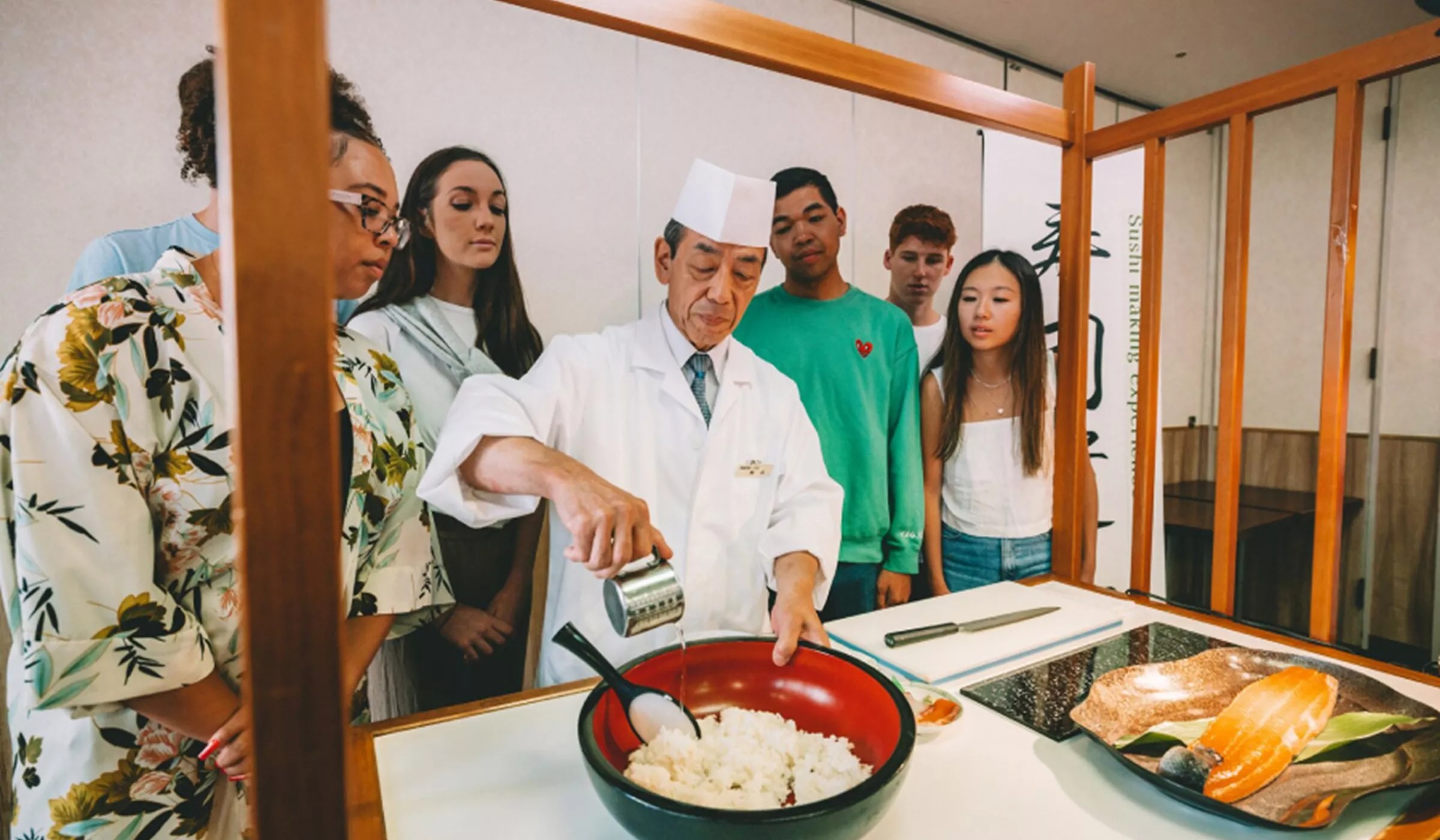 Group Of People Learning How To Do Sushi.