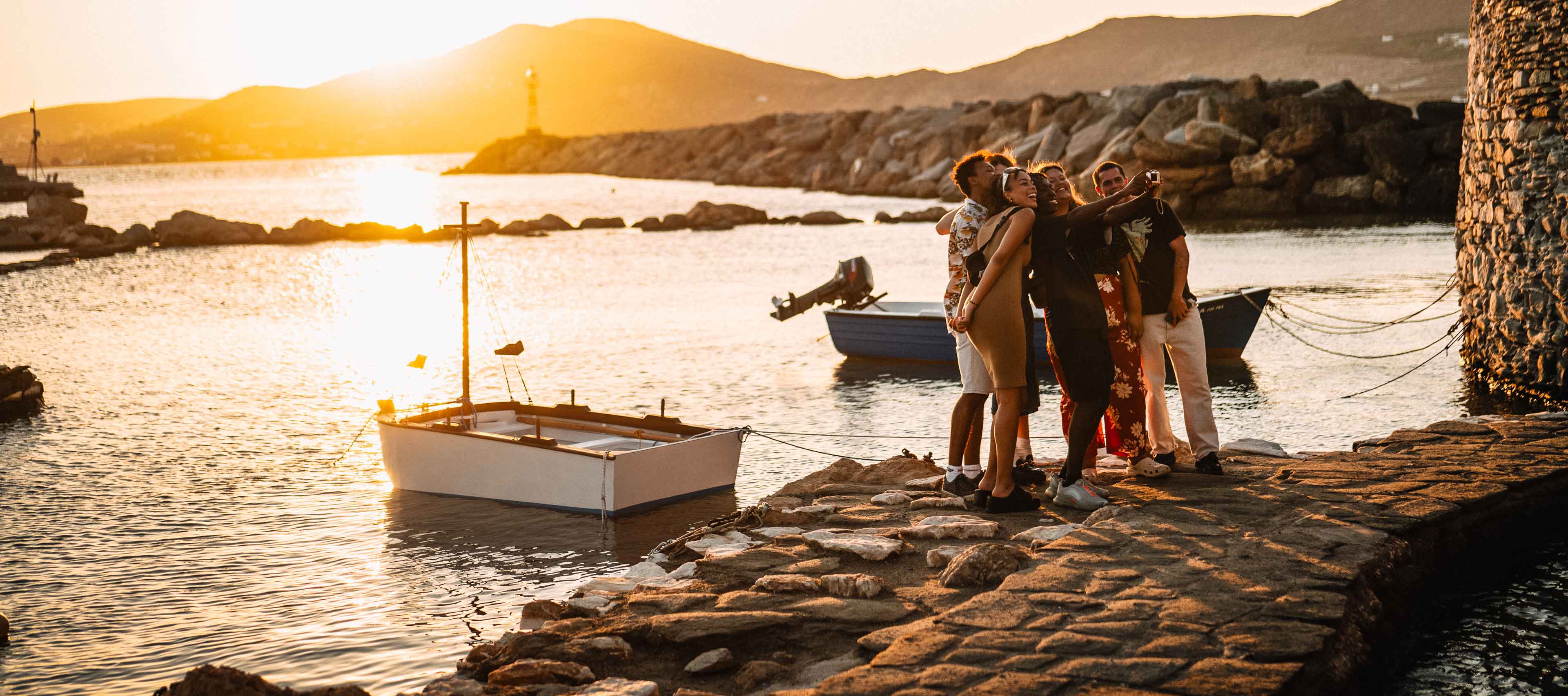 Group Of Young Travelers Taking Selfie At Sunset In Greece 