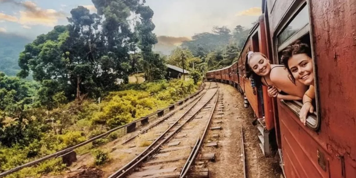 Travellers Leaning Out Of A Train In Sri Lanka