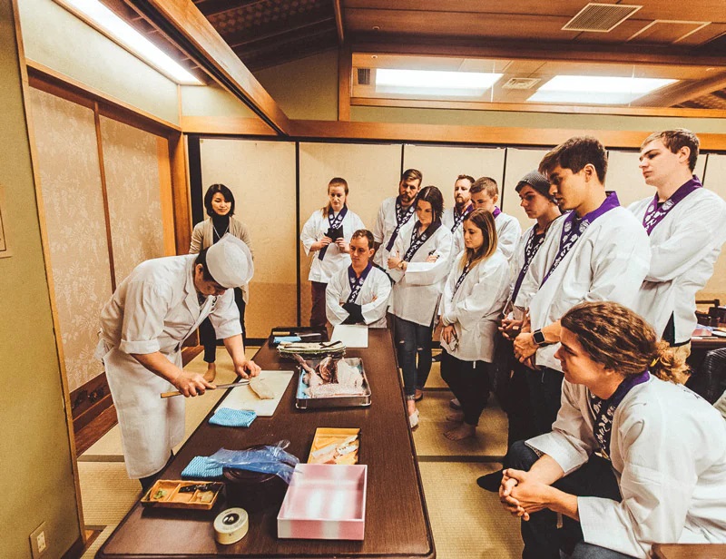 Goup of Tourists taking part in sushi cooking class