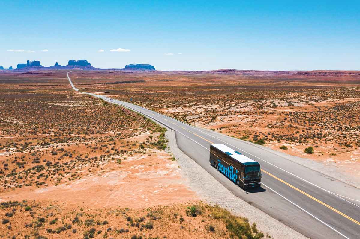 Coach Driving Through Desert In America