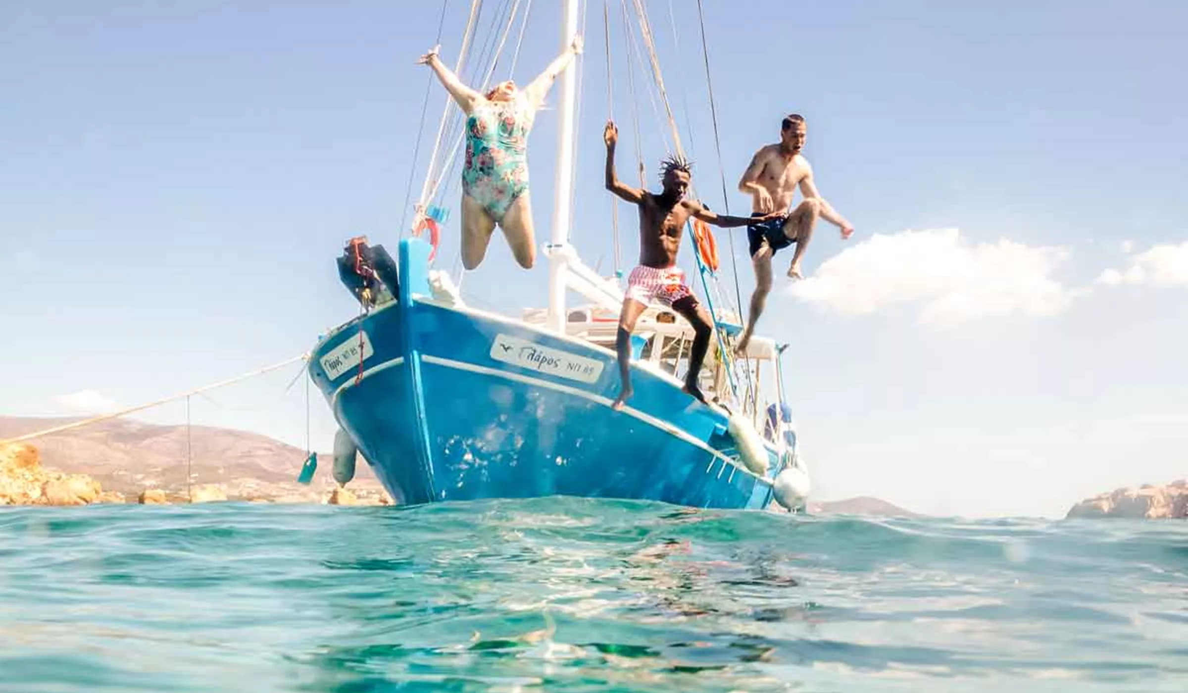 People Jumping Off A Sailing Boat In Greece