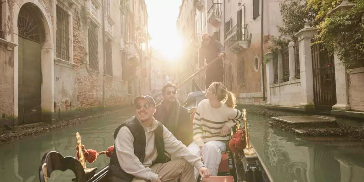 Travellers In Winter In Canals In Venice