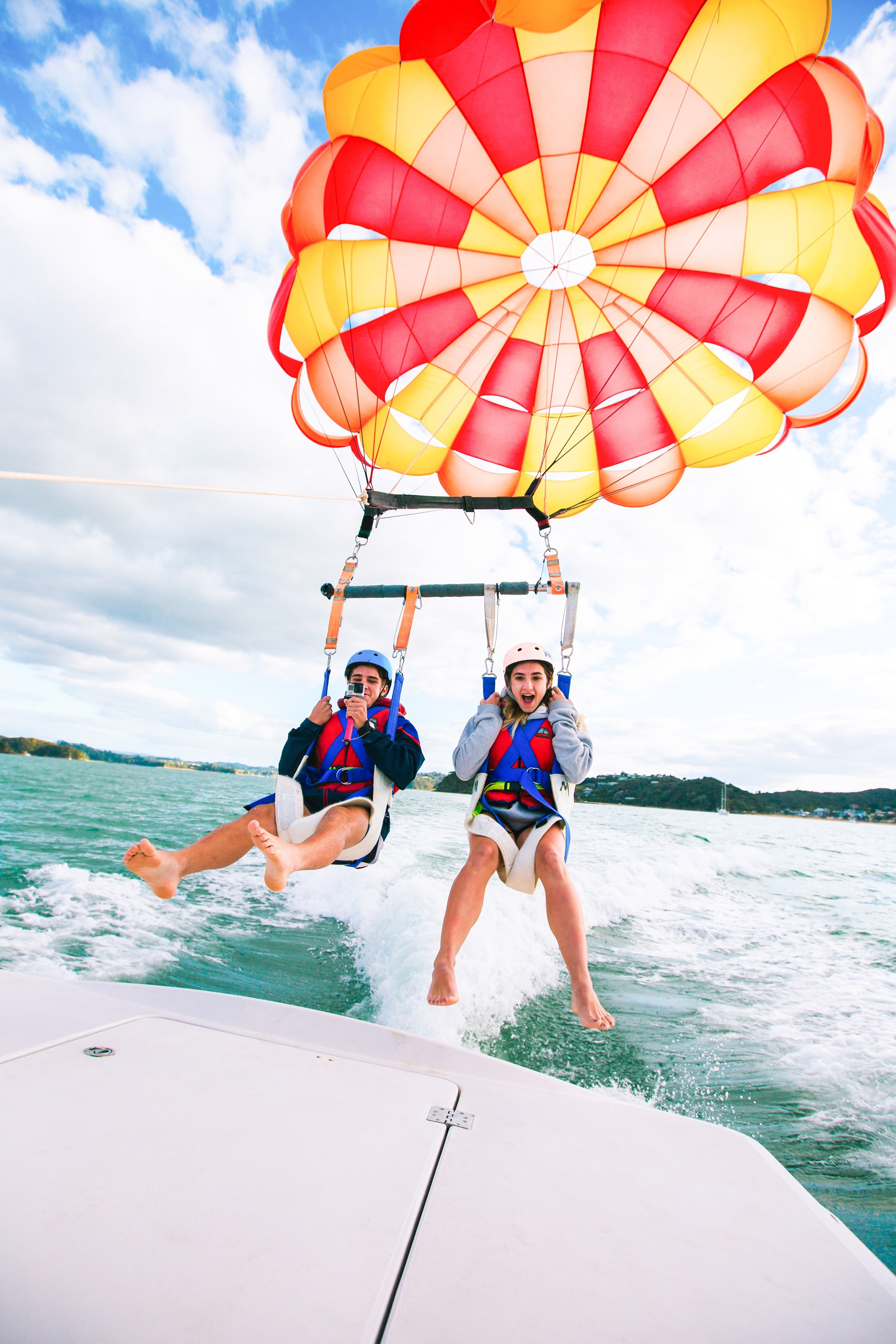 Travellers parasailing in the Bay of Island, New Zealand