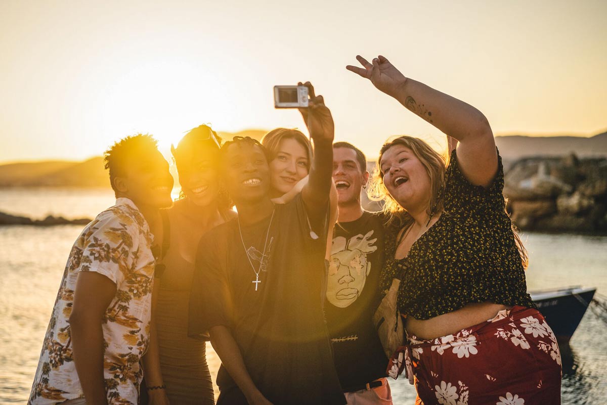 Friends Taking Picture Sunset Beach