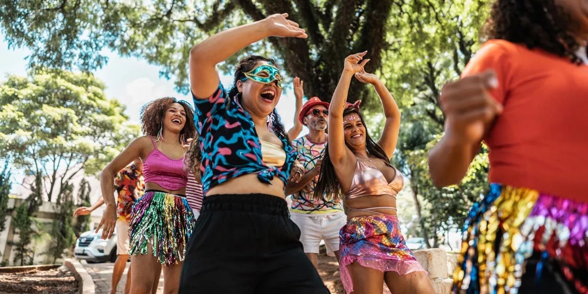 People dancing and smiling on the street in Brazil.