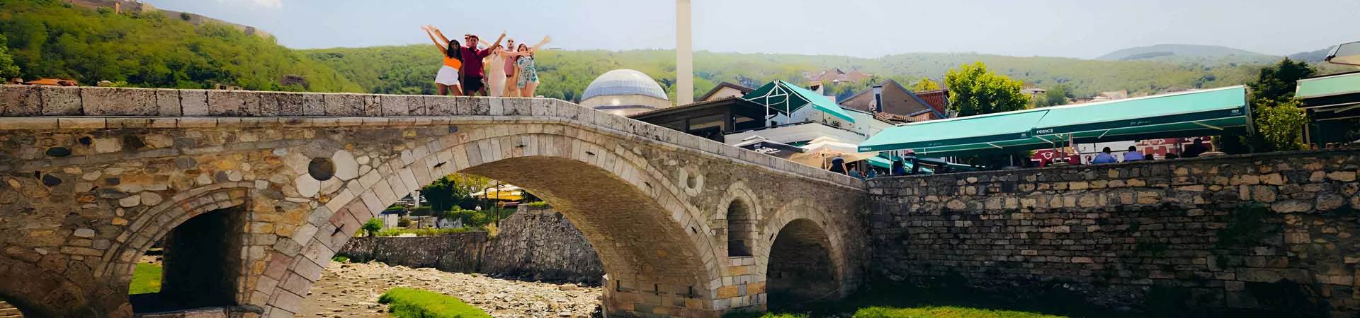 Group Of Young Travelers On Bridge In Albania