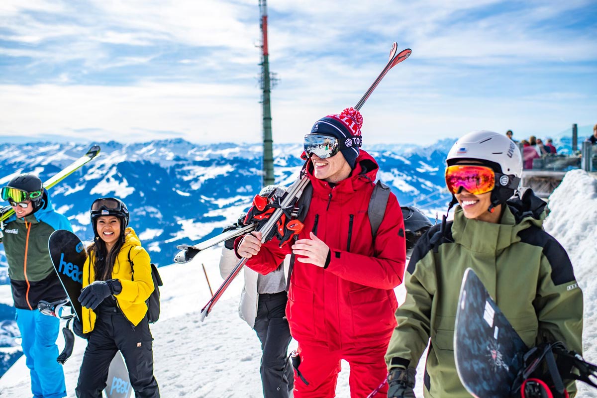 Group Of Young People Enjoying A Ski Day Snowy Mountains At The Back