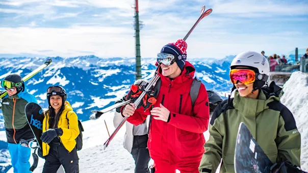 Group Of Young People Enjoying A Ski Day Snowy Mountains At The Back