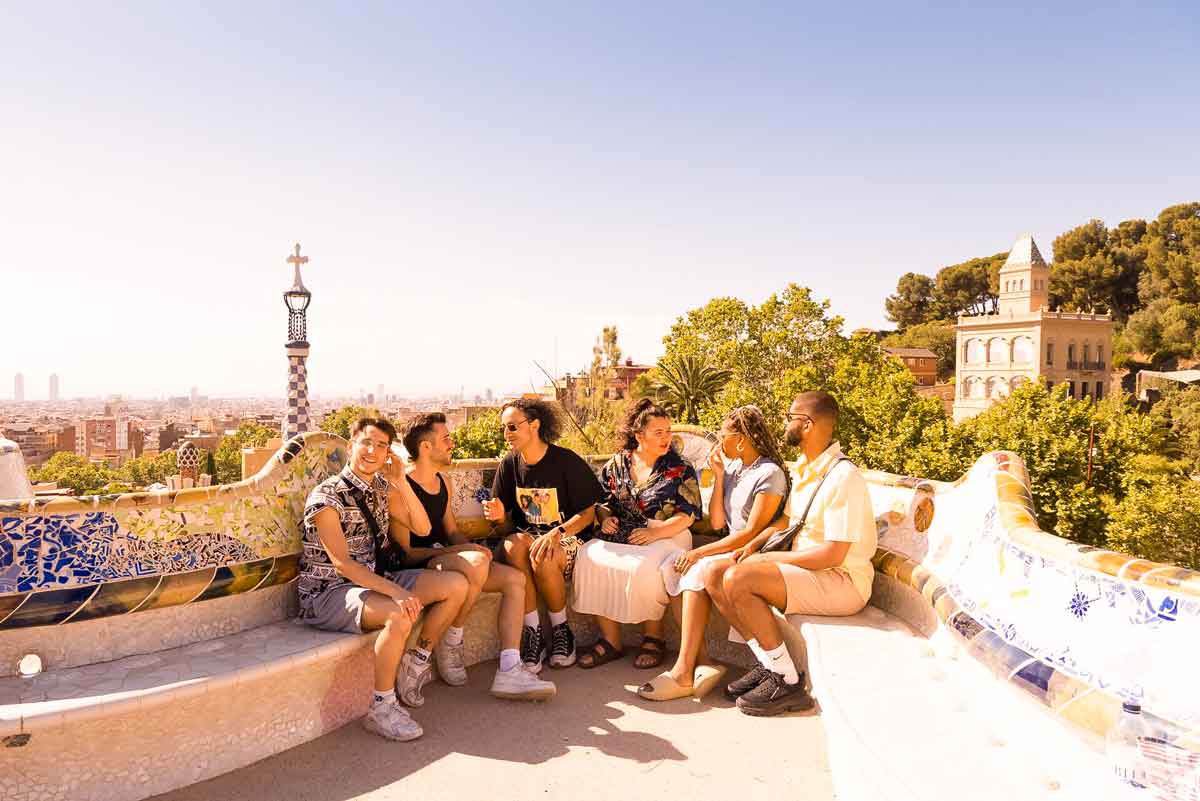Young Travellers Sitting In The Sun In Barcelona