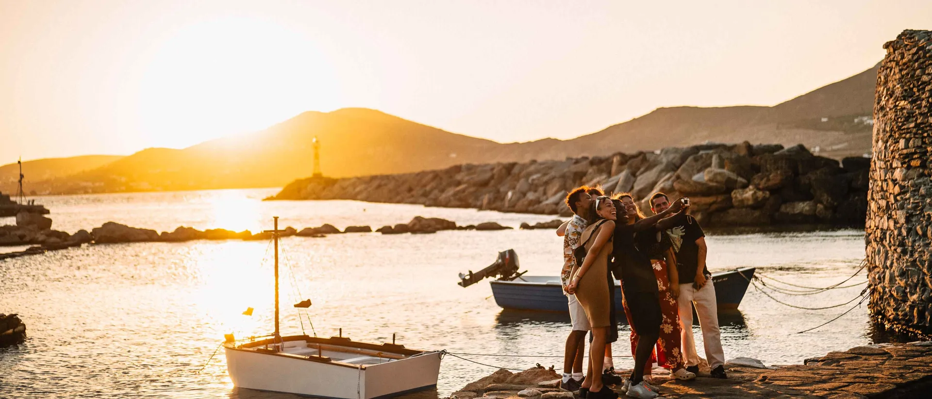 Group Of Young Travelers Taking Selfie At Sunset In Greece