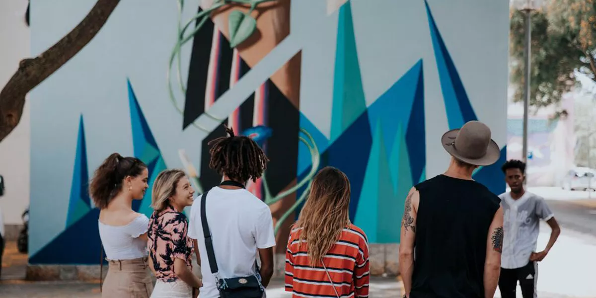 People Looking At A Grafitti