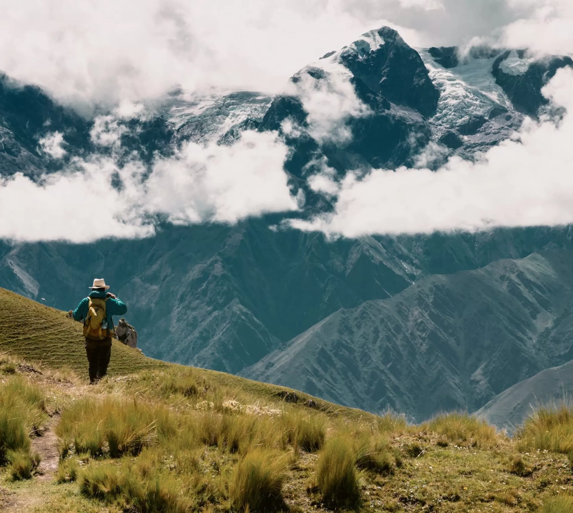 A person hikes through the breathtaking Andes Mountains on Contiki's Lima to Machu Picchu Road Trip Tour in Peru