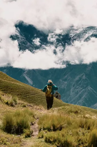 A person hikes through the breathtaking Andes Mountains on Contiki's Lima to Machu Picchu Road Trip Tour in Peru