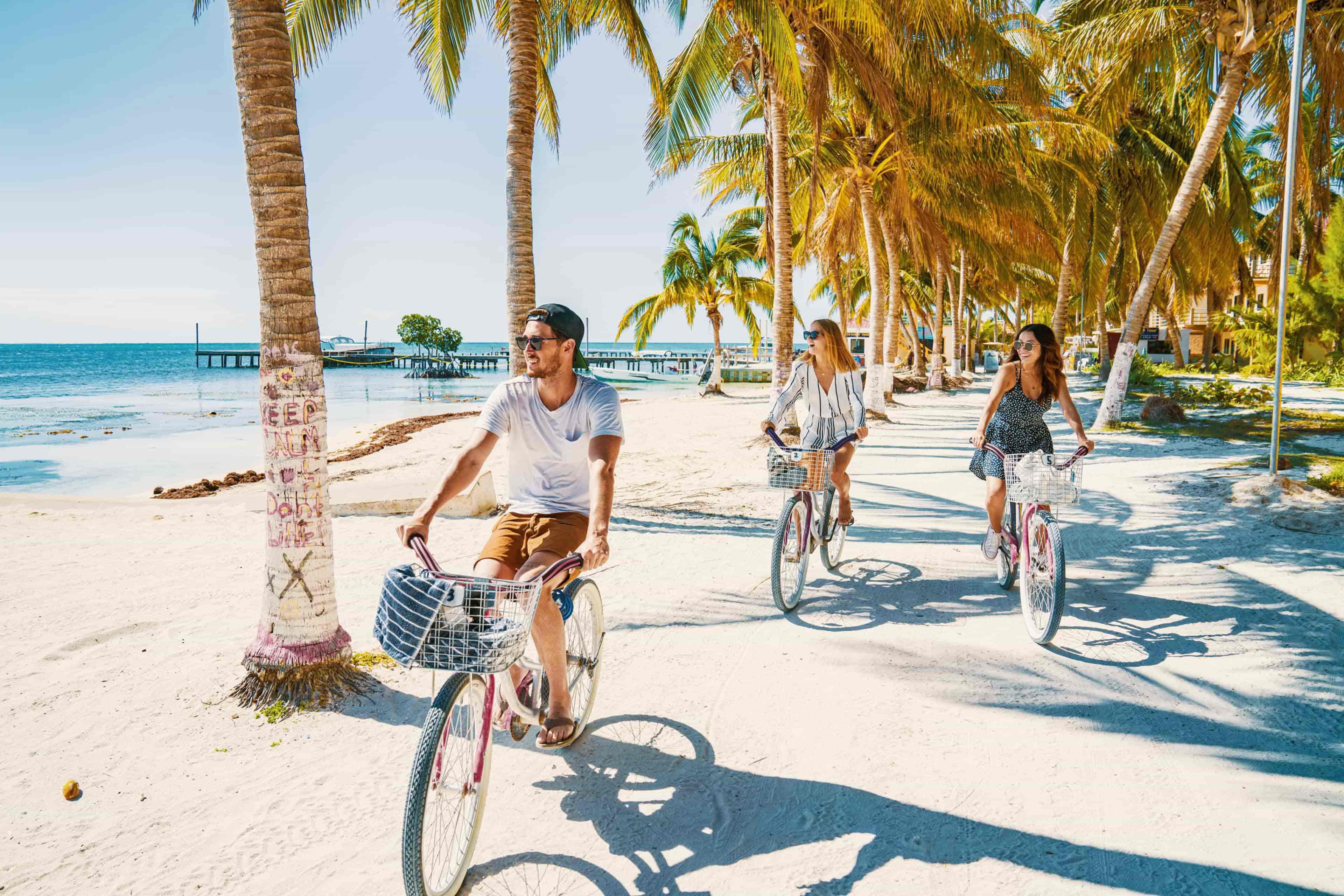 smallgroup-banner-travellers-cycle-along-beach-palm-trees-cayecaulker-belize.jpg