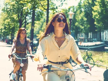 Contiki travellers cycle along Amsterdam's tree-lined canals on the European Whirl Tour