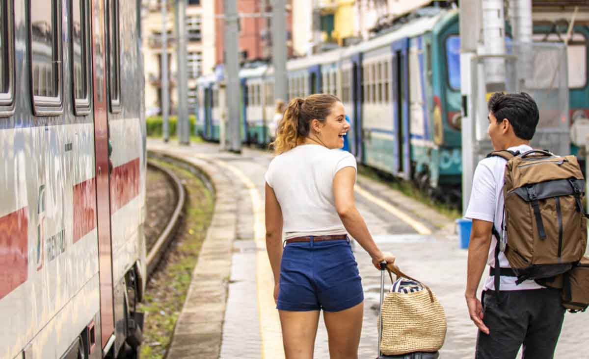 Pair At Train Station With Luggage