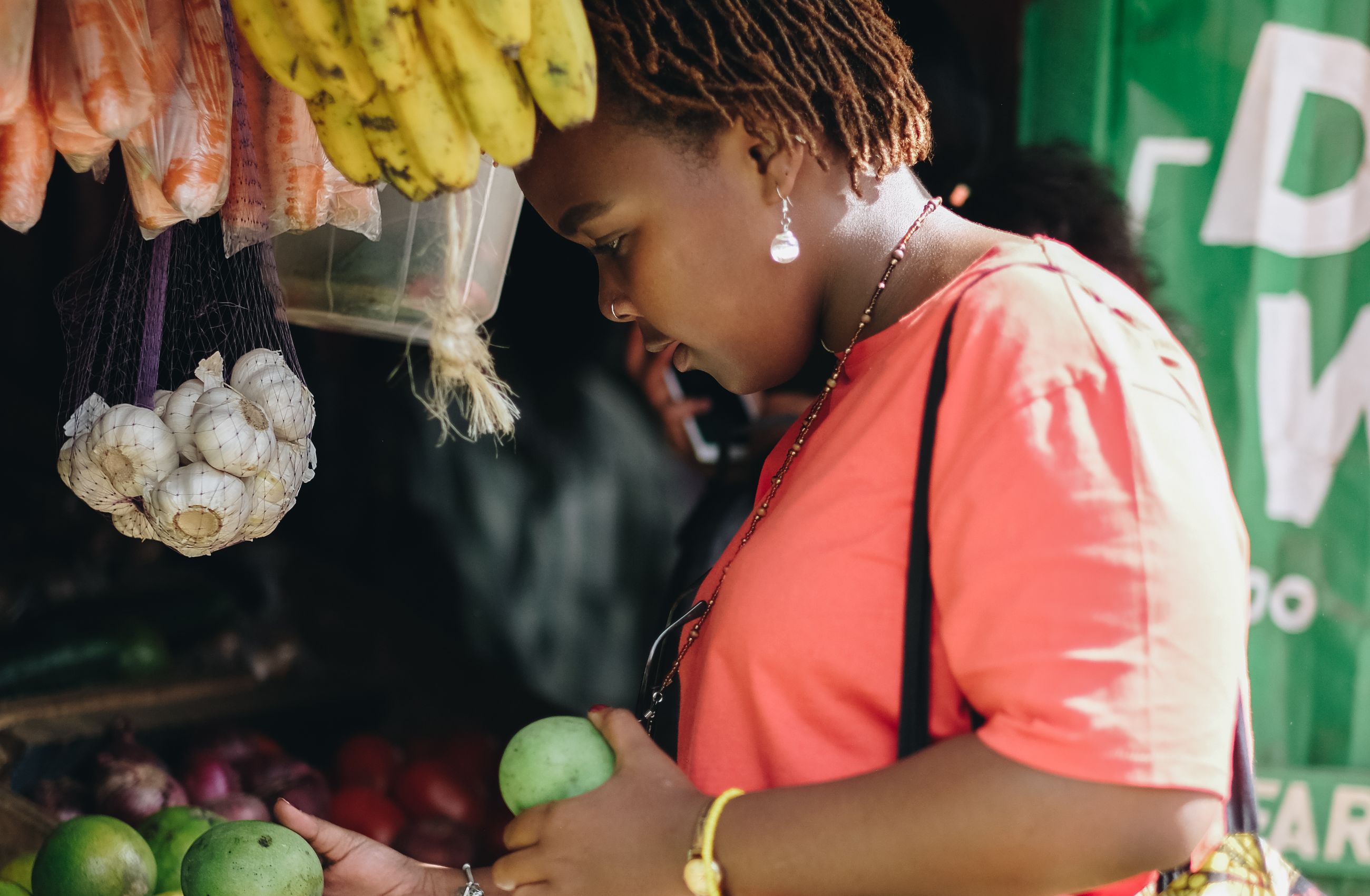 A woman shops for fruit at a market stall in Nairobi, Kenya.