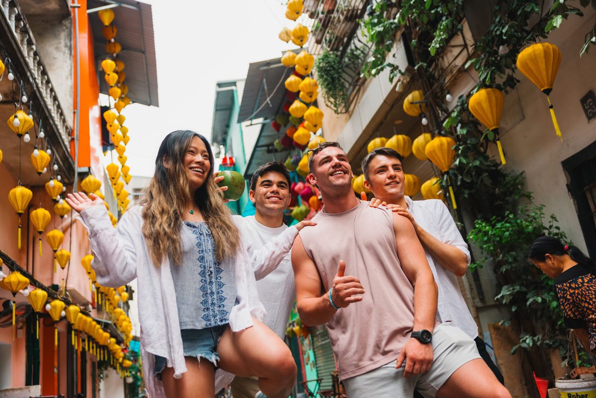Friends Walking In A Busy Road Smiling in Vietnam.