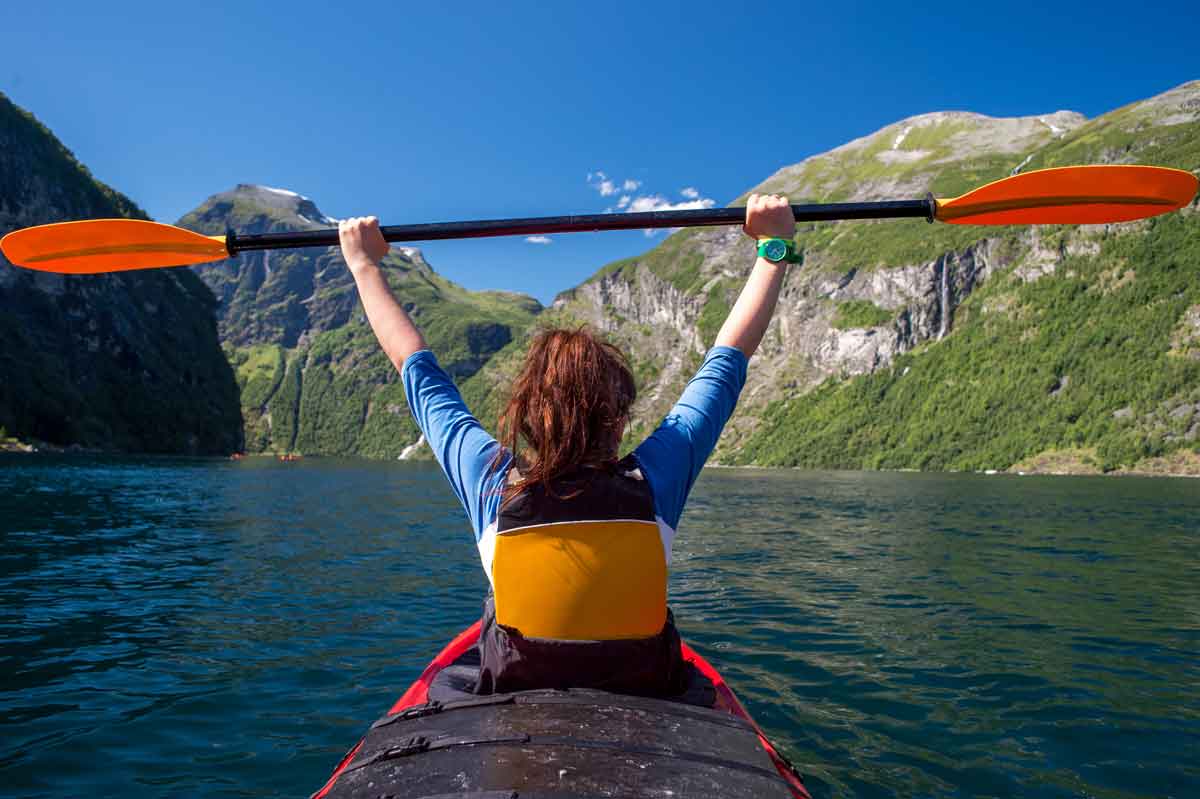 The Girl Floats On The Kayak On The Fjord