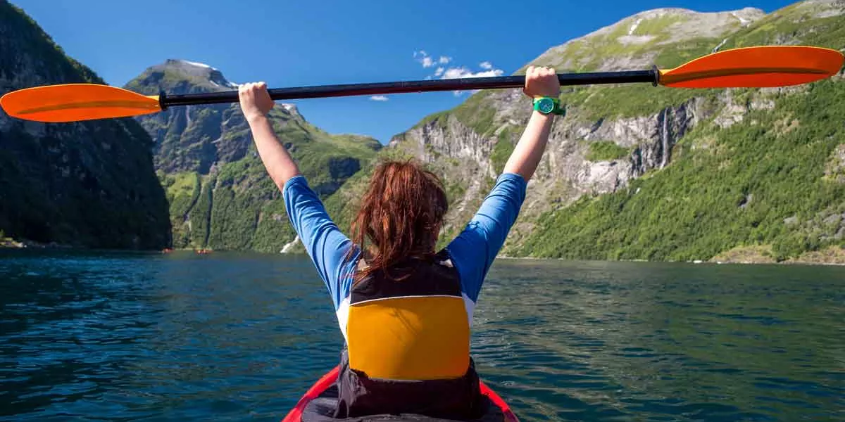 The Girl Floats On The Kayak On The Fjord
