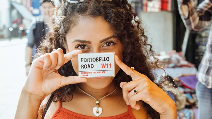 Traveller with a Portobello Road magnet in London, England
