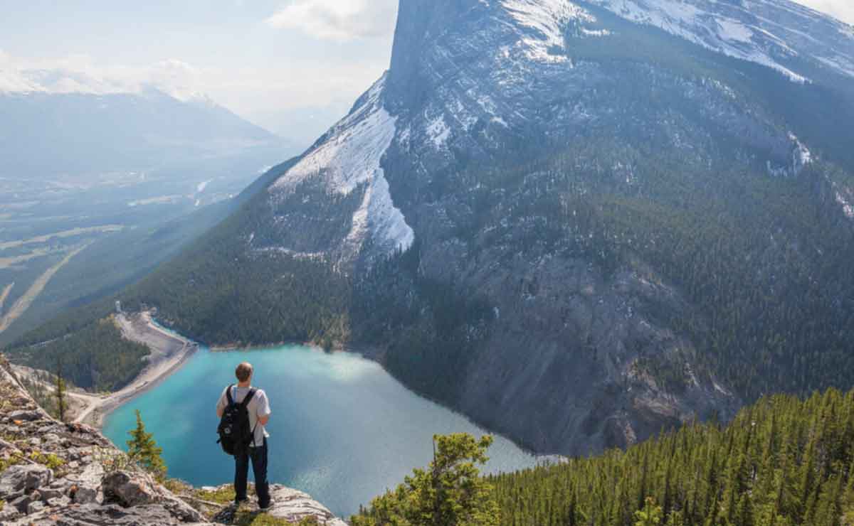 Male Looking Over Lak Mountains Canada