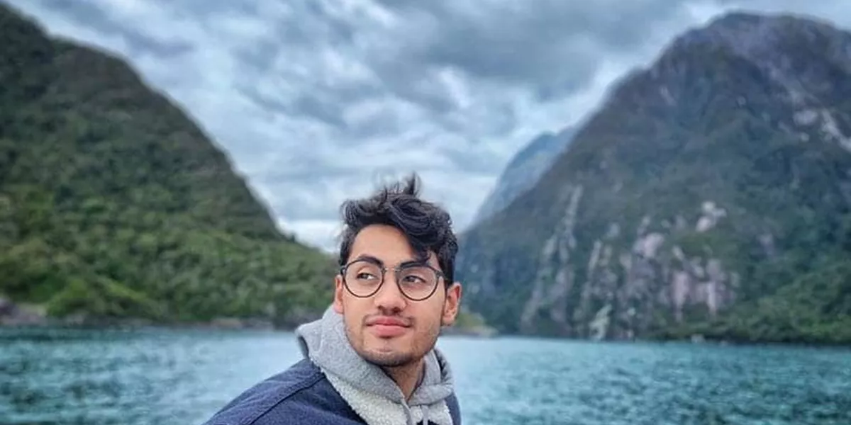 A man on the background of lake and mountains