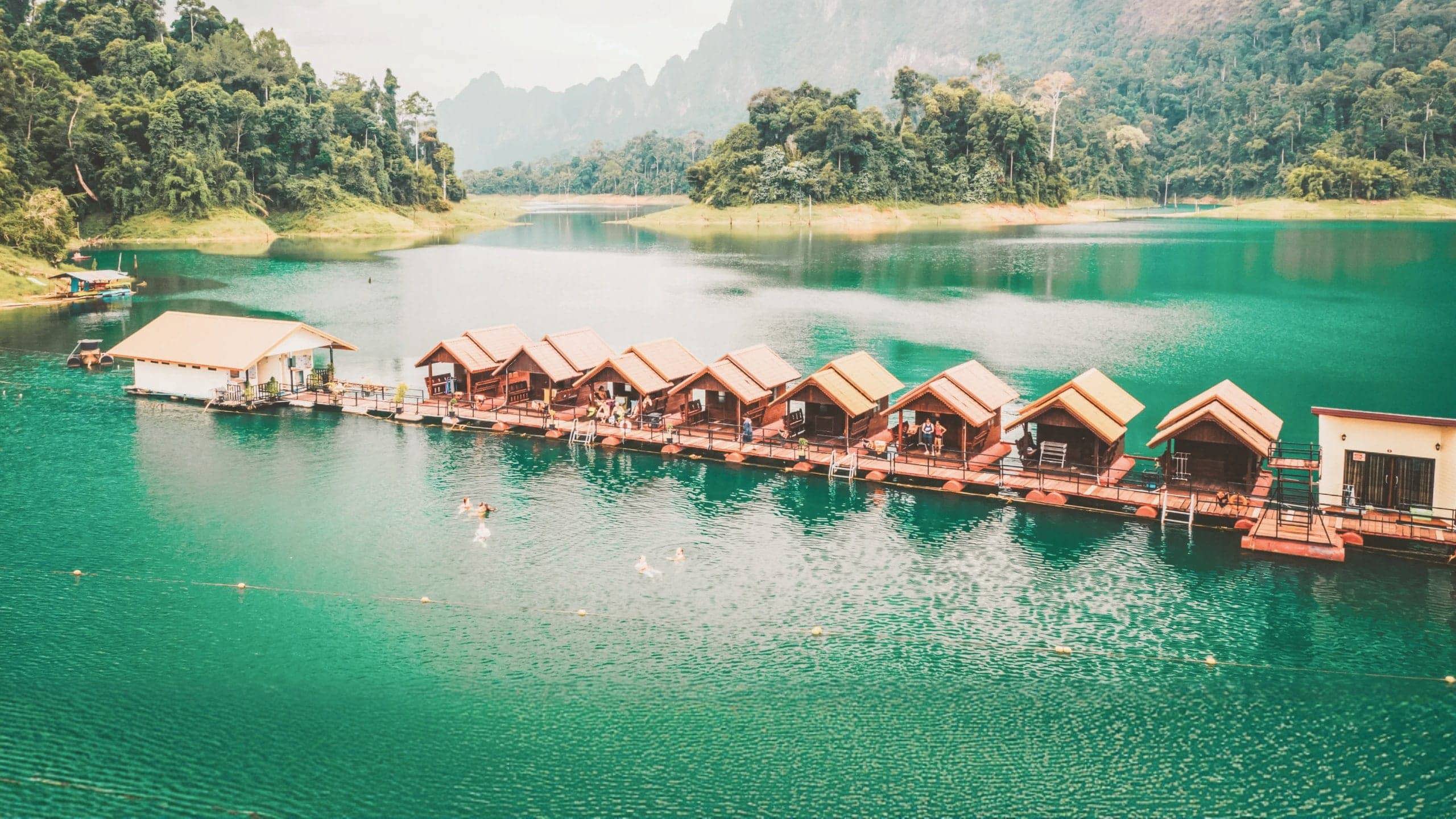 Floating raft houses surrounded by rainforest in Khao Sok National Park - Contiki Southern Thailand to Singapore Tour